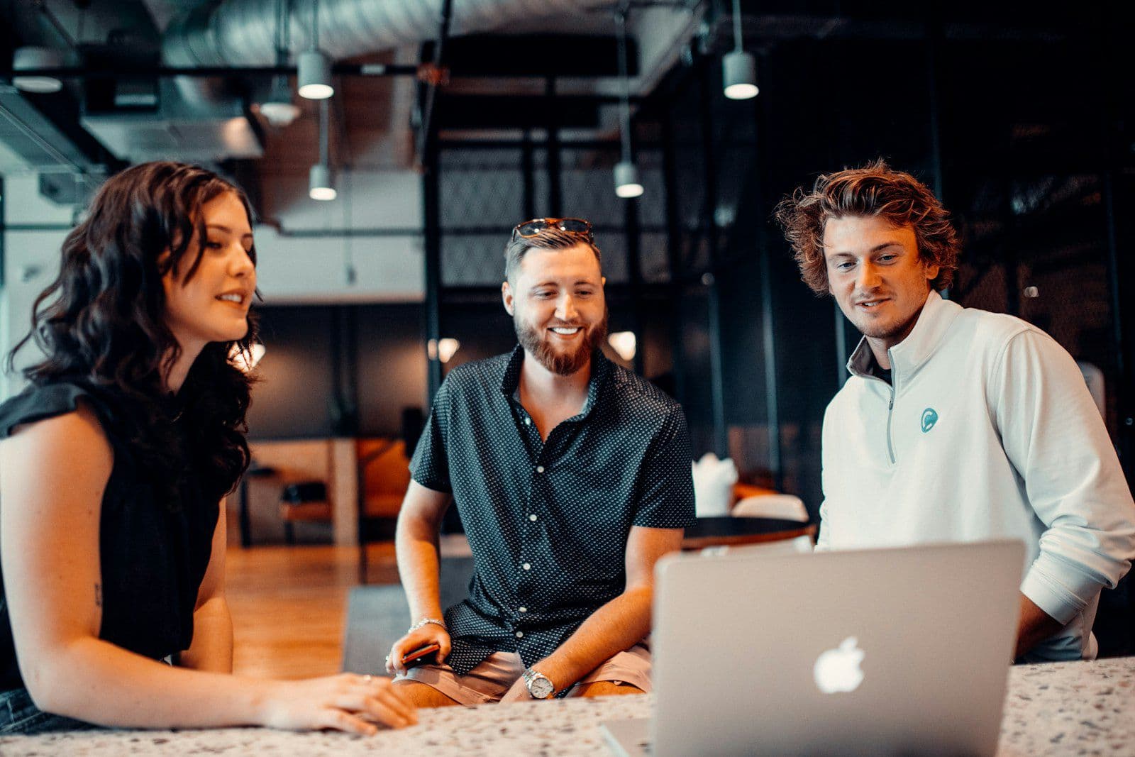 Young professionals collaborating around a laptop